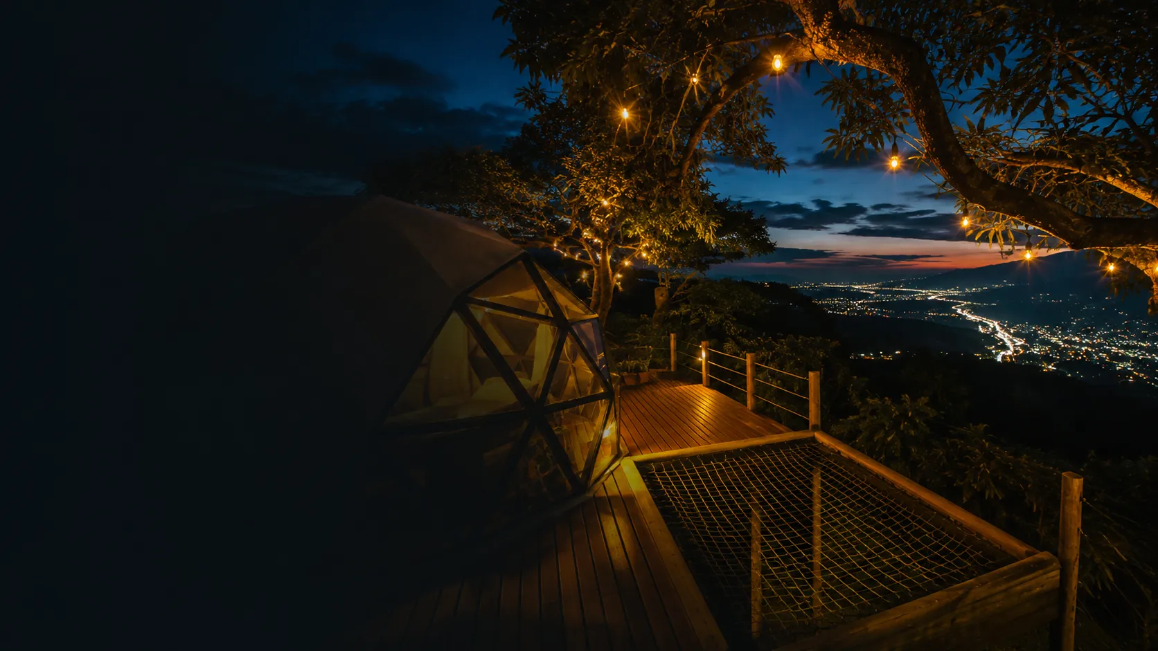 Escena nocturna en Los Angeles Glamping con las luces de la ciudad al fondo